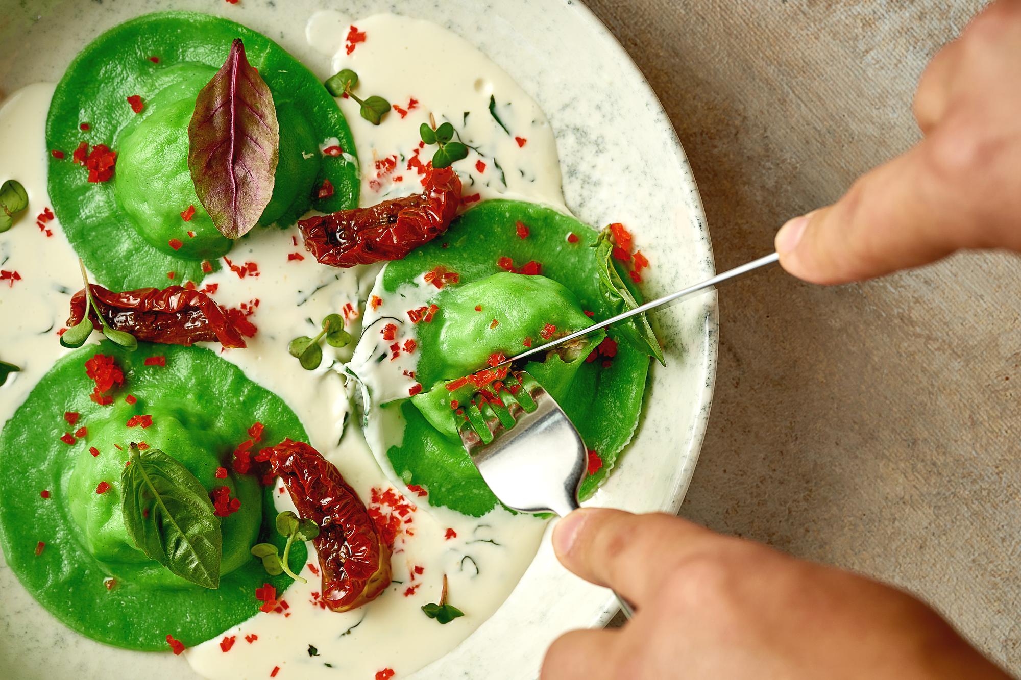Chef plating dessert with microgreens